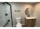 Updated bathroom featuring modern fixtures, new shower and vanity with a round mirror at 5720 Goldmount Ave, Las Vegas, NV 89107