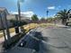 View of a gated community park with mature trees, landscaping, and walking path on a clear, sunny day at 5720 Goldmount Ave, Las Vegas, NV 89107