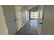 Hallway featuring gray wood-look flooring, windows, and two closets at 5720 Goldmount Ave, Las Vegas, NV 89107
