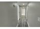 Hallway with neutral walls and hardwood floors, leading to multiple rooms at 5720 Goldmount Ave, Las Vegas, NV 89107