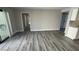 Open living space with hardwood floors, neutral walls, and access to outdoor space at 5720 Goldmount Ave, Las Vegas, NV 89107