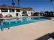 Community swimming pool and amenities with a building and landscaping at 5720 Goldmount Ave, Las Vegas, NV 89107