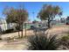 Outdoor area with tennis courts and seating surrounded by mature trees at 5720 Goldmount Ave, Las Vegas, NV 89107