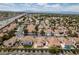 High aerial view highlighting the community, solar panels, and nearby highway at 6 Sandwedge Dr, Henderson, NV 89074