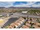 Aerial view showcasing community, solar panels, highways, and mountain views at 6 Sandwedge Dr, Henderson, NV 89074