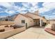 Rear exterior of the property featuring desert landscaping and a covered patio at 6 Sandwedge Dr, Henderson, NV 89074
