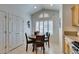 Eat-in kitchen includes a round wooden table with seating, vaulted ceiling, and plantation shutters at 6 Sandwedge Dr, Henderson, NV 89074