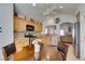 Eat-in kitchen with stainless steel appliances, wood cabinetry, and a view to the living room at 6 Sandwedge Dr, Henderson, NV 89074