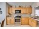 Bright kitchen boasts wood cabinets, stainless steel appliances, and granite countertops at 6 Sandwedge Dr, Henderson, NV 89074