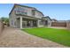 Landscaped backyard with covered patio, artificial grass, and stone at 6830 Fallen Rock St, North Las Vegas, NV 89084