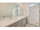 Primary bathroom featuring dual sink vanity with gray cabinets, white counters, and modern fixtures at 6830 Fallen Rock St, North Las Vegas, NV 89084