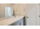 Modern bathroom featuring gray vanity with double sinks, a large mirror, and bright natural light at 6830 Fallen Rock St, North Las Vegas, NV 89084