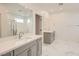 Spacious primary bath featuring a double sink vanity, separate tub, and shower, plus a large mirror at 6830 Fallen Rock St, North Las Vegas, NV 89084