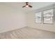 Bright bedroom featuring carpet flooring, ceiling fan, and large windows that bring in natural light at 6830 Fallen Rock St, North Las Vegas, NV 89084