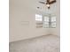Bright bedroom featuring carpet flooring, recessed lights, and large windows that bring in natural light at 6830 Fallen Rock St, North Las Vegas, NV 89084