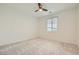 Neutral bedroom featuring a ceiling fan, window, and plush carpet at 6830 Fallen Rock St, North Las Vegas, NV 89084