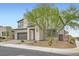 This two-story residence features stone accents, xeriscaping and a well-manicured tree at 6830 Fallen Rock St, North Las Vegas, NV 89084