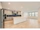 The kitchen features a large white island, stainless appliances and a blue tiled backsplash at 6830 Fallen Rock St, North Las Vegas, NV 89084