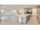 An open-concept kitchen with a large island, stainless appliances, tile backsplash and recessed lighting at 6830 Fallen Rock St, North Las Vegas, NV 89084