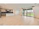 An open concept featuring a living room, kitchen with island, and large sliding glass doors to the backyard at 6830 Fallen Rock St, North Las Vegas, NV 89084