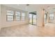 A spacious living room featuring neutral tile floors, recessed lighting and large windows for ample natural light at 6830 Fallen Rock St, North Las Vegas, NV 89084