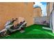 Backyard featuring artificial turf and view of stucco wall at 687 Porchtown Ave, Las Vegas, NV 89183