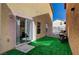 A view of the backyard and sliding door, showcasing artificial turf at 687 Porchtown Ave, Las Vegas, NV 89183