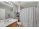 Bathroom featuring vanity, sink, mirror, shower with patterned curtain, and tiled floors at 687 Porchtown Ave, Las Vegas, NV 89183