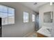 Bright bathroom showcasing a vanity, mirror, tile floor, and natural light from multiple windows at 687 Porchtown Ave, Las Vegas, NV 89183