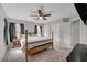 Bedroom with four-poster bed, carpet, ceiling fan, and large double door closet at 687 Porchtown Ave, Las Vegas, NV 89183