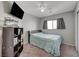 Cozy bedroom featuring a soft bed, shelving, and a window, offering a comfortable living space at 687 Porchtown Ave, Las Vegas, NV 89183