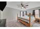 Cozy bedroom featuring four poster bed frame, ceiling fan, and ample natural light at 687 Porchtown Ave, Las Vegas, NV 89183