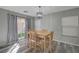 Bright dining area with modern light fixture, slider to backyard, and comfortable wooden chairs at 687 Porchtown Ave, Las Vegas, NV 89183