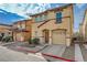Charming two-story home with a terracotta roof, attached garage, and neat front yard at 687 Porchtown Ave, Las Vegas, NV 89183