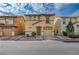 Charming two-story home featuring a terracotta roof, attached garage, and quaint front yard at 687 Porchtown Ave, Las Vegas, NV 89183