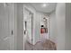Upstairs hallway with carpet, open doorway to bedroom with ceiling fan and desk at 687 Porchtown Ave, Las Vegas, NV 89183