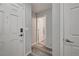 Hallway view with wood-look floors leading to a room with a white door at 687 Porchtown Ave, Las Vegas, NV 89183