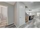 Inviting hallway leading to a living area with wood-look flooring and modern neutral color palette at 687 Porchtown Ave, Las Vegas, NV 89183