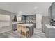 Modern kitchen featuring gray cabinets, stainless steel appliances, and a center island with bar seating at 687 Porchtown Ave, Las Vegas, NV 89183