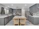 Stylish modern kitchen features gray cabinets, an island, and stainless steel appliances at 687 Porchtown Ave, Las Vegas, NV 89183