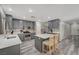Modern kitchen with gray cabinets, stainless steel appliances, and a center island with bar seating at 687 Porchtown Ave, Las Vegas, NV 89183