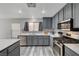 Stylish kitchen featuring gray cabinets, stainless steel appliances and white quartz countertops at 687 Porchtown Ave, Las Vegas, NV 89183