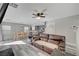 Open-concept layout of the living room area with dining space and stylish gray wood flooring at 687 Porchtown Ave, Las Vegas, NV 89183