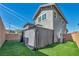 Two-story home featuring backyard with gazebo, artificial turf, and neutral-colored stucco exterior at 688 Monroe Hill Pl, Henderson, NV 89011