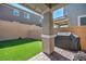 Outdoor space with artificial turf, patio area, grill, and brick perimeter wall at 688 Monroe Hill Pl, Henderson, NV 89011