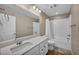 Bright bathroom with a shower-tub combo, a large mirror, and quartz counters at 688 Monroe Hill Pl, Henderson, NV 89011