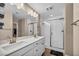 Bathroom with double sink vanity, a glass-enclosed shower, and tile flooring at 688 Monroe Hill Pl, Henderson, NV 89011