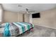 Comfortable bedroom featuring plush carpet, ceiling fan, and a wall-mounted TV at 688 Monroe Hill Pl, Henderson, NV 89011