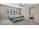 Bright bedroom with plush carpet, ceiling fan, and ensuite bathroom at 688 Monroe Hill Pl, Henderson, NV 89011