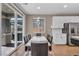 Bright dining area features sliding glass doors to the backyard, modern lighting, and ample space at 688 Monroe Hill Pl, Henderson, NV 89011